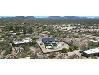 Beautiful aerial view of the property with a pool and manicured outdoor space amidst a desert landscape at 26626 N 70Th Pl, Scottsdale, AZ 85266