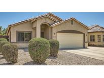 Charming home featuring a two-car garage, landscaped yard, and an inviting entryway at 2853 E Cathy Dr, Gilbert, AZ 85296