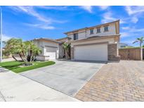 Beautiful two story home featuring a spacious three car garage and a well manicured front yard at 3139 E Runaway Bay Pl, Chandler, AZ 85249