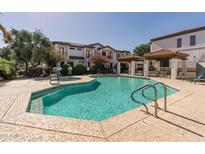 Community pool with hot tub and covered seating area, perfect for relaxing and enjoying the outdoors at 3150 E Beardsley Rd # 1023, Phoenix, AZ 85050
