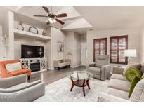 Inviting living room featuring vaulted ceilings, stylish furnishings, and a cozy fireplace at 3301 S Goldfield Rd # 6050, Apache Junction, AZ 85119