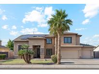 Stunning two-story home featuring a spacious three-car garage, lush landscaping, and a welcoming front entrance at 3574 E Latham Way, Gilbert, AZ 85297