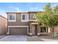 Charming two-story home featuring a neutral color scheme and a well-manicured front yard at 409 E Saddle Way, San Tan Valley, AZ 85143