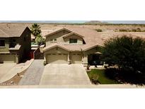 Gorgeous two-story home with tile roof and three-car garage in a beautiful desert setting at 44236 W Adobe Cir, Maricopa, AZ 85139