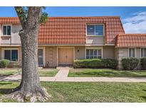 Inviting townhome featuring a unique red-tiled roof, manicured lawn, and a charming front entrance at 5166 N 83Rd St, Scottsdale, AZ 85250