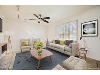 Bright living room with a ceiling fan, modern furnishings, large windows, and an accent wall at 5166 N 83Rd St, Scottsdale, AZ 85250
