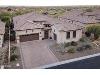Beautiful single-Gathering home featuring a brick driveway and well-maintained desert landscaping at 8433 E Leonora St, Mesa, AZ 85207