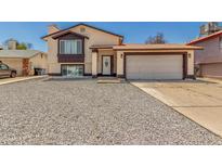 Charming two-story home featuring a two-car garage and low-maintenance gravel landscaping at 8829 W Sheridan St, Phoenix, AZ 85037