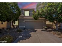 Charming two-story home with a well-maintained lawn and a two car garage at 11526 W Bermuda Dr, Avondale, AZ 85392