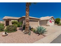 Charming home featuring desert landscaping, multiple garages and views of Arizona blue skies at 11543 W Sandsnake Ct, Surprise, AZ 85378