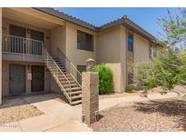 Tan apartment building featuring exterior stairs and desert landscaping at 1402 E Guadalupe Rd # 234, Tempe, AZ 85283