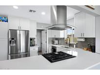 Bright kitchen boasts sleek countertops, stainless steel appliances, and updated fixtures for a modern feel at 1615 E Roma Ave, Phoenix, AZ 85016