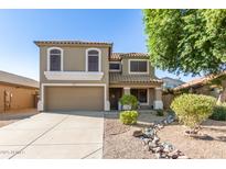 Charming two-story home with desert landscaping, a two-car garage, and a covered front porch at 16527 W Ironwood St, Surprise, AZ 85388