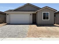 Charming single-Gathering home featuring a two-car garage and a well-maintained front yard with modern hardscape at 18165 W Larkspur Dr, Goodyear, AZ 85338