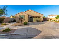 Charming single-story home with a well-maintained front yard and a two-car garage at 21084 E Cherrywood Dr, Queen Creek, AZ 85142