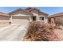 Charming single-story home with a two-car garage, desert landscaping, and a covered entryway at 22534 W Pima St, Buckeye, AZ 85326