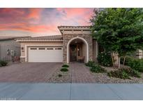 Charming single-story home with a brick-paved driveway and stone-accented entryway at 24953 N 172Nd Dr, Surprise, AZ 85387