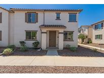 Charming townhome featuring a covered entryway, desert landscaping, and a neutral color palette at 2640 N 73Rd Gln, Phoenix, AZ 85035