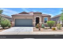 Charming single-story home featuring a tile roof, desert landscaping, and a two-car garage at 36467 W Pampoloma Ave, Maricopa, AZ 85138