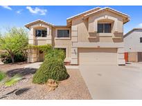 Inviting two-story home featuring a neutral color palette, well-kept landscaping, and attached two-car garage at 3786 S Chaparral Rd, Apache Junction, AZ 85119