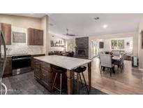 Open concept kitchen flowing into the living room featuring a large center island at 3964 S Turquoise Dr, Buckeye, AZ 85326