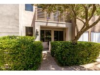 Inviting condo exterior featuring well-maintained landscaping and a covered entrance at 4343 N 21St St # 158, Phoenix, AZ 85016