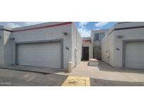 Charming townhome exterior with attached garages and desert landscaping at 4733 W Eva St, Glendale, AZ 85302