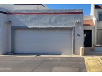 Attached one car garage with white door and stucco facade at 4733 W Eva St, Glendale, AZ 85302