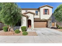 Charming two-story home featuring a front yard, desert landscaping and a two car garage at 6641 N Desert Shadow Ln, Phoenix, AZ 85014
