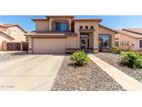 Charming two-story home featuring neutral stucco, manicured landscaping, and a two-car garage at 8555 W Purdue Ave, Peoria, AZ 85345
