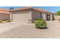 Charming single-story home featuring a two-car garage, desert landscaping, and a classic tile roof at 17434 N 46Th Pl, Phoenix, AZ 85032