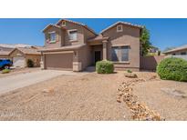 Two-story home features a well-kept yard, attached garage, and neutral-toned stucco exterior at 10228 E Carol Ave, Mesa, AZ 85208