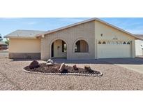 Charming single-story home with desert landscaping and light brick facade in a well-maintained community at 1051 S 81St Way, Mesa, AZ 85208