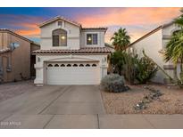 Charming two-story home featuring a spacious driveway, a two-car garage, and desert landscaping at 1414 E Cathedral Rock Dr, Phoenix, AZ 85048