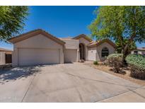 Charming single-story home featuring a three-car garage, neutral stucco, and low maintenance landscaping at 14771 W Columbus Ave, Goodyear, AZ 85395