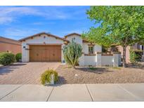 Charming single-story home featuring a two-car garage, well-maintained landscaping, and desert plants at 1768 E Grand Ridge Rd, Queen Creek, AZ 85140