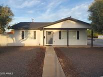 Charming single story home featuring a gray door, gray trim, and a well maintained front yard at 1922 N 21St Pl, Phoenix, AZ 85006