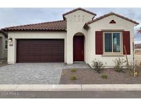 Charming single-story home with red tiled roof, a two-car garage, and desert landscaping at 20346 W Sells Dr, Buckeye, AZ 85396