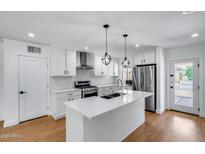 Renovated kitchen featuring a large island, stainless steel appliances, and pendant lighting at 2336 E Flower St, Phoenix, AZ 85016