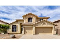 Inviting two-story home showcasing a well-manicured yard and attached two-car garage at 3132 E Wildwood Dr, Phoenix, AZ 85048