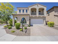 Charming two-story home with a balcony, arched windows and a well-manicured front yard at 3310 E Los Gatos Dr, Phoenix, AZ 85050
