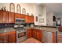Well-equipped kitchen with stainless steel appliances and granite countertops offers a modern and stylish design at 4083 E Rustler Way, Gilbert, AZ 85297