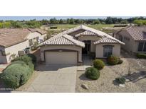 Charming single-story home featuring a tile roof, well-maintained landscaping, and a two-car garage at 4316 E Strawberry Dr, Gilbert, AZ 85298