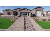 Beautiful model home showcasing desert landscape, brick pathway and stunning exterior elevation at 43712 N Acadia Way, New River, AZ 85087