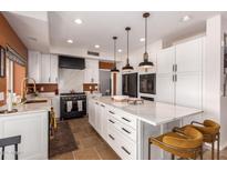 Modern kitchen with stainless steel appliances, white cabinetry, and quartz countertops at 4727 E Rancho Caliente Dr, Cave Creek, AZ 85331