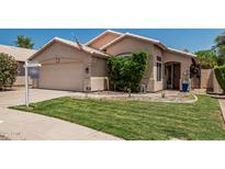 Charming single-story home featuring a well-maintained lawn and two-car garage at 51 N Rush St, Chandler, AZ 85226