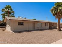 Charming single-story home featuring desert landscaping, a covered patio, and ample parking at 5415 E Butte St, Mesa, AZ 85205