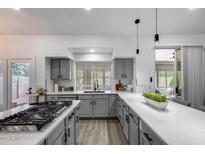 Bright kitchen with quartz countertops, stainless steel appliances, and a gas range cooktop at 8449 W Rockwood Dr, Peoria, AZ 85382