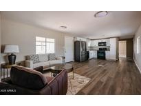 Bright living room featuring modern furniture, wood-look floors, and a seamless flow into the kitchen at 8600 E Broadway Rd # 53, Mesa, AZ 85208