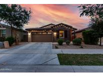 Charming single-Gathering home boasting a two-car garage and stone veneer, complemented by a well-manicured lawn at 9831 E Tupelo Ave, Mesa, AZ 85212